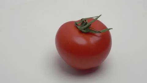 Red tomato rotates on a white background. Video stock 265952666