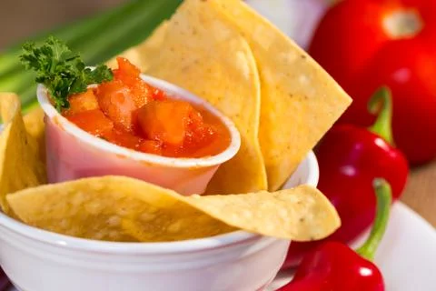Red tomato salsa with corn chips. Stock Photos