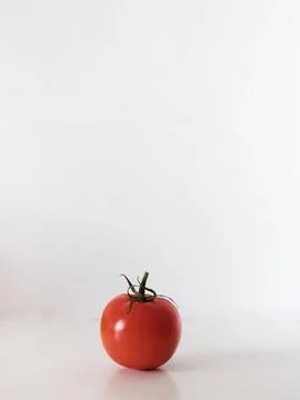 A red tomato sits on a white background Stock Photos