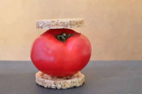 Red tomato on a wheat bread Stock Photos
