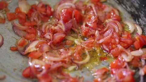 Red tomatoes and pepper fried in vegetable oil in the pan. Stock Footage 131445794