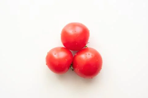 Red tomatoes arranged in a triangle shape. View from above Stock Photos