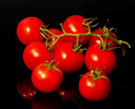 Red tomatoes on black background Stock Photos