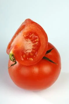 Red tomatoes on a blue background 스톡 사진