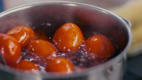 Red tomatoes boiling and stir with a spoon in a metal pan. Healthy eating Stock Footage 135236737