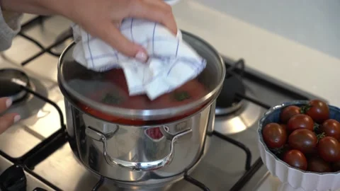 Red Tomatoes Boiling And Stir With A Spoon In A Metal Pan. Video stock 162600036