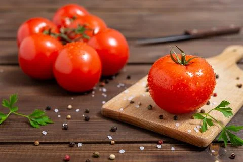 Red tomatoes on cutting board Stock Photos