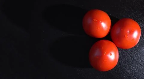 Red Tomatoes on Dark Background Stock-Fotos
