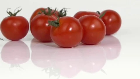 Red tomatoes falling on a white background Stock Footage 83054598