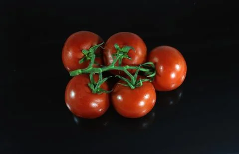 Red tomatoes on the isolated and reflected black background Foto stock