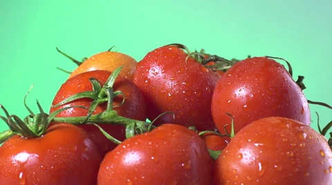 Red Tomatoes isolated rotating on green background Stock Footage 62414322