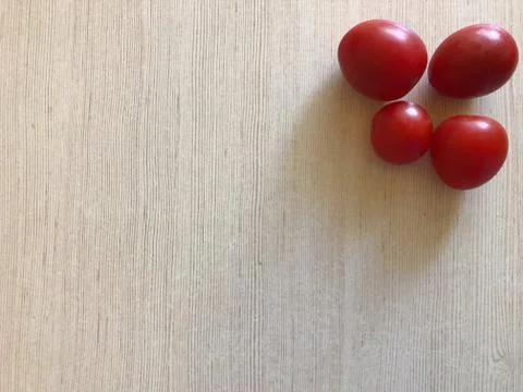 Red tomatoes on a light background with free space Stock Photos