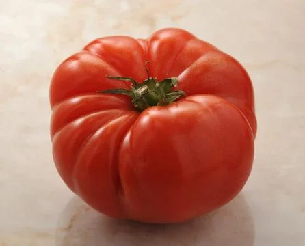 Red tomatoes on a marble background Stock Photos
