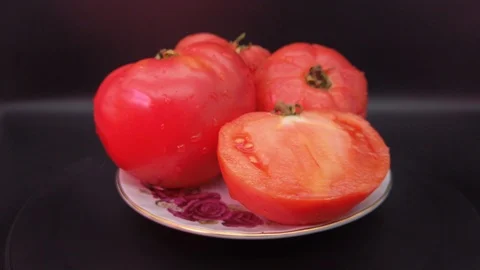 Red tomatoes in a plate on a black background Stock-Footage 113554911