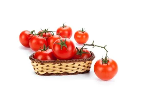 Red tomatoes in a small basket on a white background Stock Photos