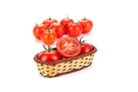 Red tomatoes in a small basket on a white background 库存照片