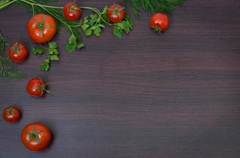 Red tomatoes  on a table on the background of vegetables. Stock Photos