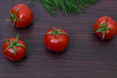 Red tomatoes  on a table on the background of vegetables. Fresh vegetables Stock Photos