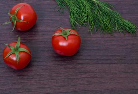 Red tomatoes  on a table on the background of vegetables. Fresh vegetables Stock Photos