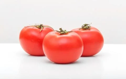 Red tomatoes on white Stock Photos