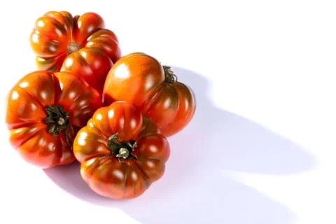 Red tomatoes on a white table Stock Photos