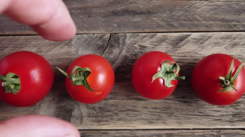 Red tomatoes on a wooden background Video stock 201321489