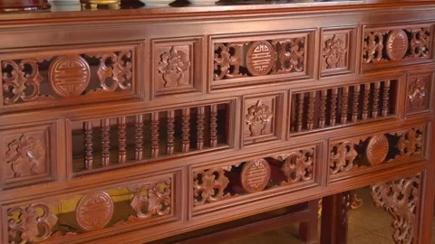 Red-toned altar cabinet features intricate, traditional Asian wood carving Stock Footage 340628338