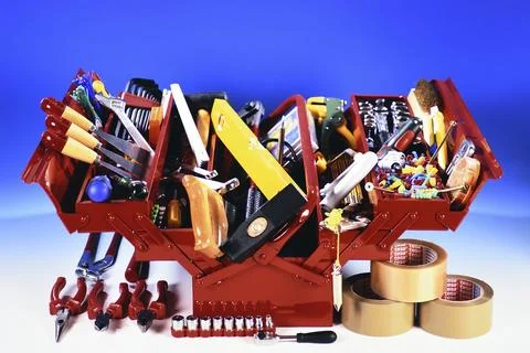 A red toolbox with tools, hammer, screwdriver, adhesive tape, folding rule, Stock Photos