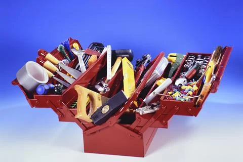 A red toolbox with tools, hammer, screwdriver, adhesive tape, folding rule, Stock Photos