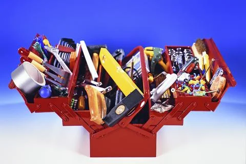 A red toolbox with tools, hammer, screwdriver, adhesive tape, folding rule, Stock Photos