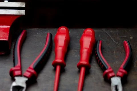 Red tools on a work table on a black background Stock Photos