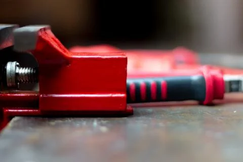 Red tools on a work table on a black background, toolroom concept Stock Photos