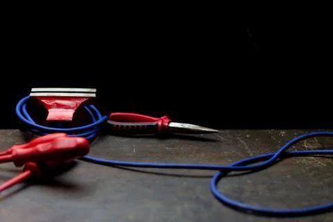 Red tools on a work table on a black background, toolroom concept Stock Photos