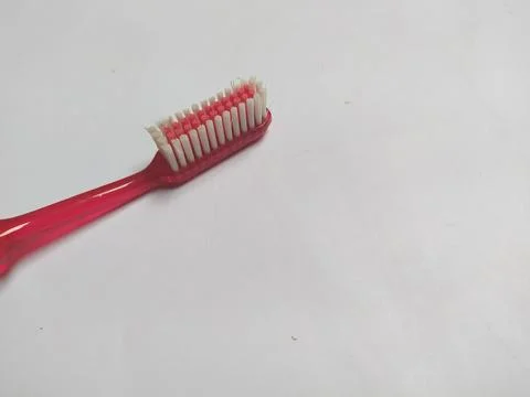 Red toothbrush on gray background Stock Photos