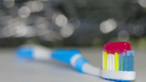 Red toothpaste on a toothbrush Stock Footage 82533569