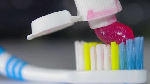 Red toothpaste on a toothbrush (macro) Stock Footage 82533572