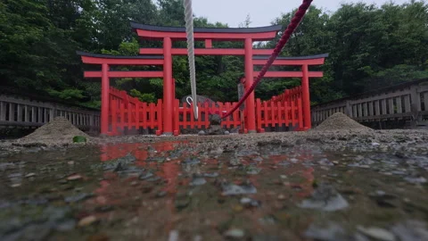 Red Torii Gate in Heavy Rain Reflection Kamado Shrine Fukuoka 4K Stock Footage 342323748