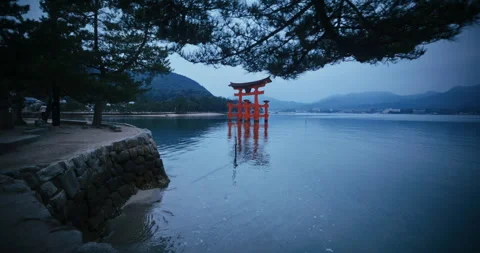 Red Torii Gate Standing in Calm Bay at Dusk Miyajima Japan Stock Footage 344700450
