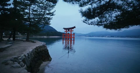 Red Torii Gate Standing in Calm Bay at Dusk Miyajima Japan Stock Footage 344700475