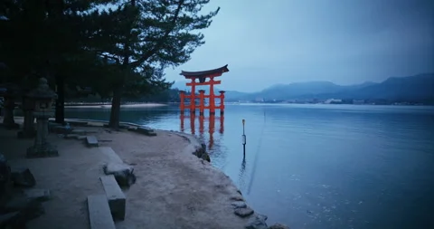 Red Torii Gate Standing in Water at Dusk Hiroshima Japan Video stock 344700318