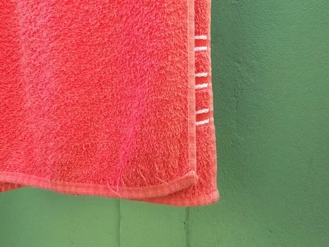 Red towel on clothesline, shaking with the wind Stock Footage 112074380