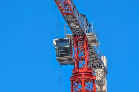 Red Tower Crane in Action: Bold Engineering Against a Bright Blue Sky Stock Photos