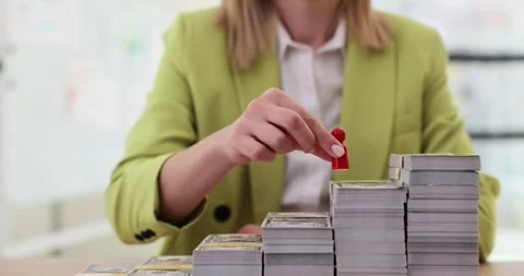 Red toy man walking on stacks of dollars money closeup 4k movie slow motion Stock Footage 260340215
