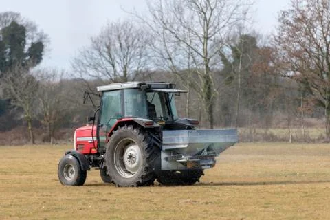 Red tractor with automatic lime spreader Stock Photos