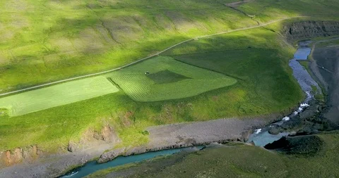 Red tractor driving in ever decreasing circles in Húnavatnshreppur, Iceland Video stock 93804865
