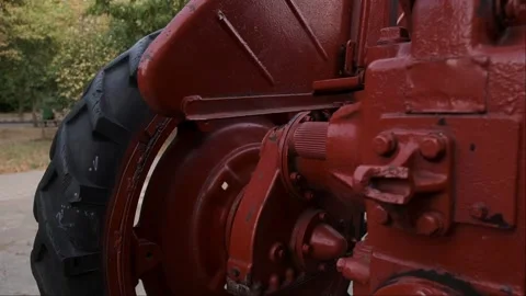 A red tractor in a forest area. Ideal for small land plots where high power is n Stock Footage 300349435