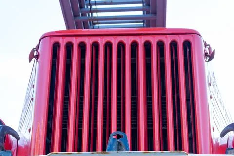 Red tractor front grill with vertical slats and metal details Stock Photos