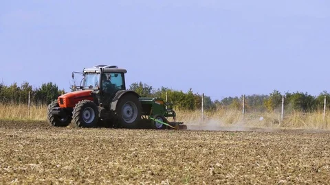 Red Tractor Mounted Seed Drill Plants the Seeds in the Soil in the Experimental Stock Footage 84631318