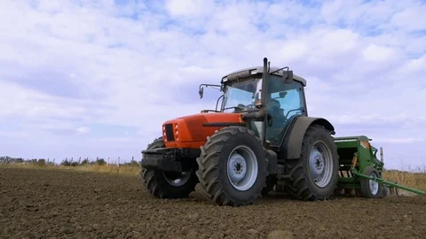Red Tractor Mounted Seed Drill Plants the Seeds in the Soil in the Experimental Stock Footage 84657732
