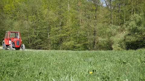 Red tractor parked in forest Stock Footage 107061122